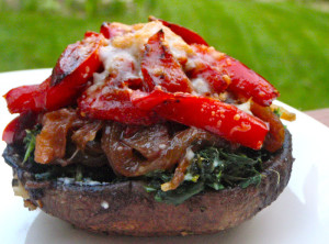 Portobello mushroom stuffed with yellow onion, red pepper, spinach and cheese.